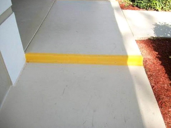 Yellow paint on sidewalk step